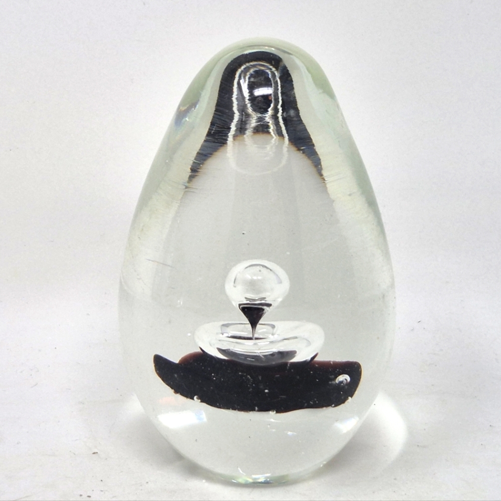 Art Glass Egg Shape Paperweight With White And Black Center With Bubbles.